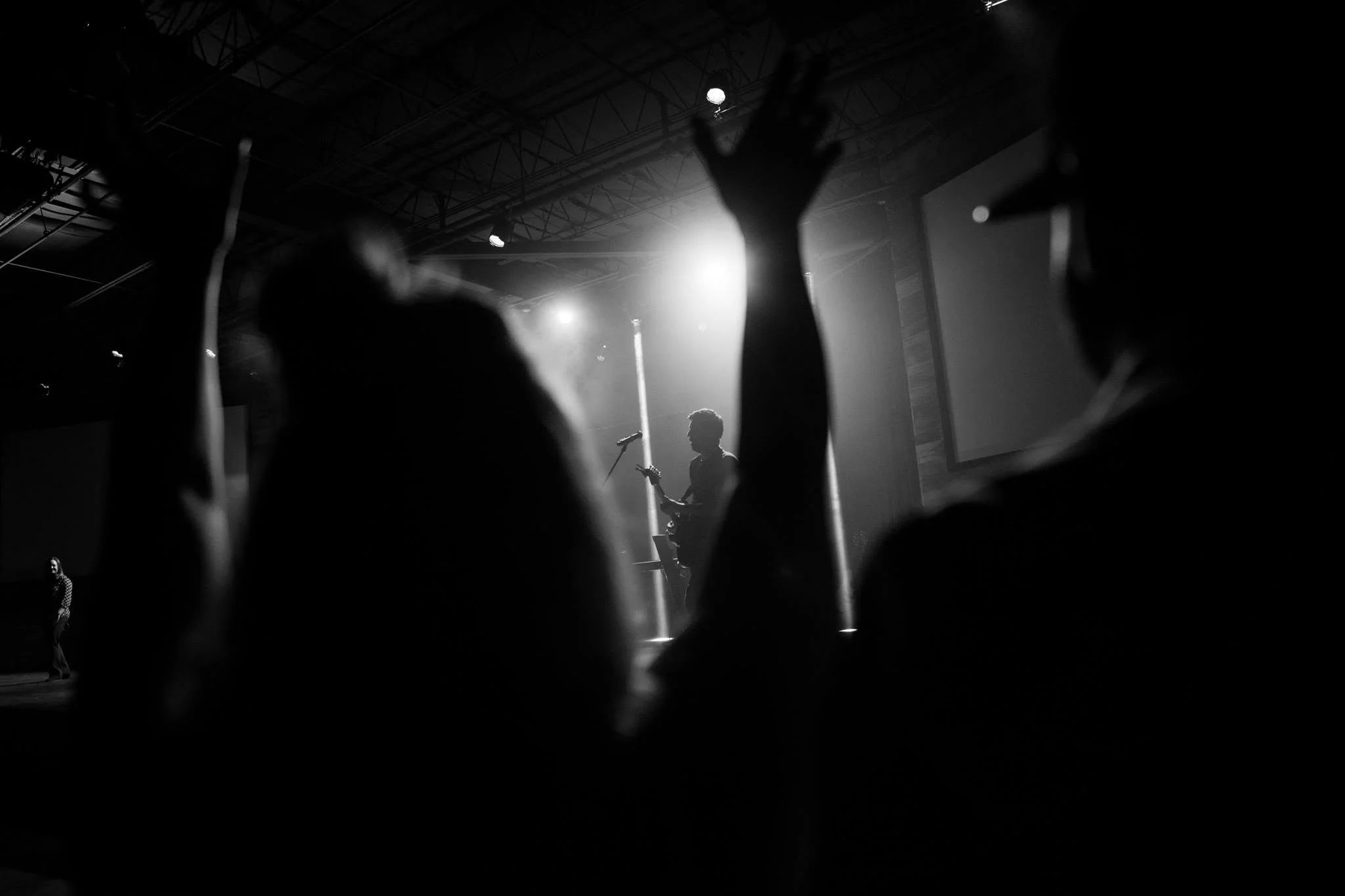 A worship service Jon helped produce, stage lights and raised hands